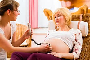 Berufshaftpflichtversicherung Hebamme – Hebamme untersucht Schwangere